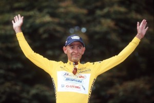 Marco Pantani wearing the yellow jersey after winning the Tour de France in Paris, 1998 – Credit: SVEN SIMON/DPA/Press Association Images
